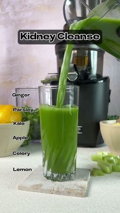 a green smoothie being poured into a blender with ingredients labeled in the words kidney cleanse