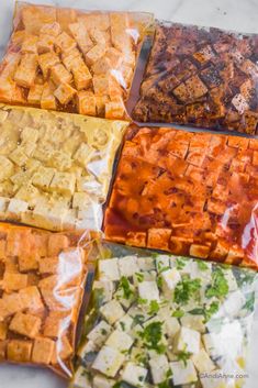 four bags of food sitting on top of a counter next to each other in different colors