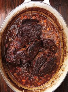 beef stew in a pot on a wooden table