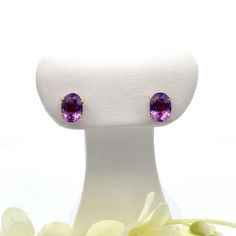 These handmade vintage oval amethyst gemstone earrings (circa approximately 1950s) are made in 18k gold.   The ear backs ar extra large for security. Metal Content: 18k Yellow Gold Stones: Natural Amethyst Number of Stones: 2 Cut: Oval faceted Size in mm: 8 x 6 Measurements Length:  5/16" (8mm) Width:  1/4" (6mm) Weight: 1.8 Grams Stamps: 18k Condition: Excellent pre-owned Items will ship in a gift box or pouch Each piece is thoroughly examined and refinished as needed by our professional jewelers, tested to guarantee metal content,  graded by our in-house GIA (Gemological Institute of America) Graduate Gemologist, and inspected for quality before being carefully packaged and promptly shipped. Thank you for taking the time to shop with us! We have hundreds of more listings, with more being Purple Oval Fine Jewelry Earrings, Classic Oval Lavender Jewelry, Elegant Oval Purple Gemstones, Purple Oval Earrings With Gemstone Accents, Elegant Purple Oval Gemstones, Classic Lavender Oval Jewelry, Classic Oval Earrings With Gemstone Accents, Elegant Oval Amethyst Earrings, Classic Oval Purple Gemstones