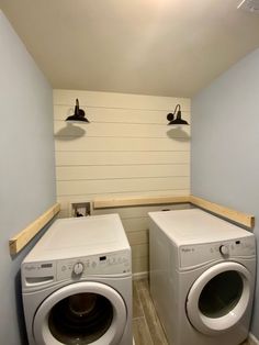 two washers and dryer in a small room