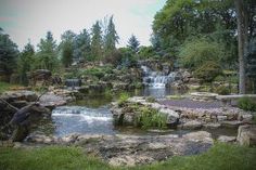 there is a waterfall in the middle of this garden