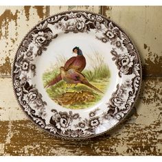 a plate with two pheasants painted on the front and back of it