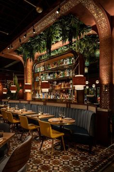 the interior of a restaurant with many tables and chairs