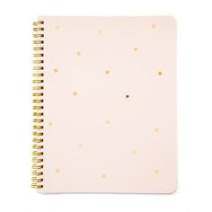 a pink notebook with gold dots on it