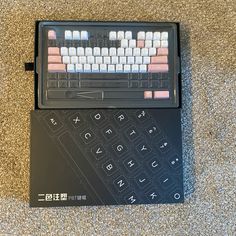 a computer keyboard sitting on top of a black box