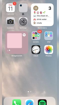 an iphone screen with several different icons on the phone and in the background there are clouds