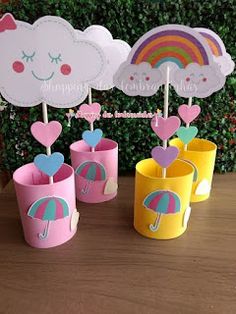 there are cup holders with umbrellas and clouds on top of each one in the shape of hearts