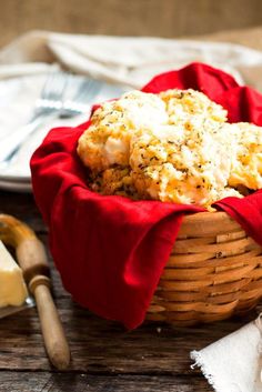 a basket filled with food sitting on top of a table next to a knife and fork