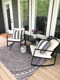 two chairs and a table on a porch