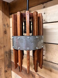 a wind chime hanging from the side of a wooden wall