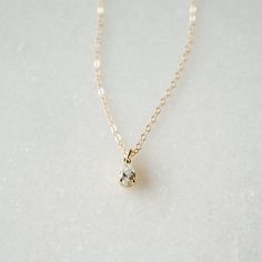 Our Tiny Teardrop Necklace is a gorgeous addition to your everyday look. The sparkling tiny teardrop charm hangs from our long-lasting 14K gold filled or Sterling silver chain. This is the perfect gift for a friend (or yourself) as it is so dainty and ready for everyday wear. You really can't go wrong!FEATURES Tiny teardrop Cubic Zirconia charm 14K gold filled or Sterling silver chain Model is wearing 16" length All necklace findings (clasp, jump rings, tag) & chain are 14K gold filled/Sterl Ariel Necklace, Small Gold Necklace, Gold Necklace Simple, Jewel Necklace, Dainty Gold Necklace, Cz Necklace, Teardrop Necklace, Pretty Earrings, Minimalist Necklace