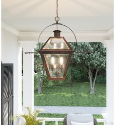 a light hanging from the ceiling over a porch