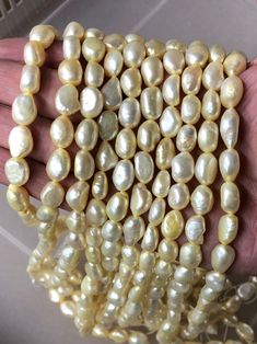 a bunch of pearls that are in someone's hand