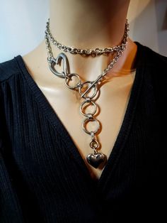 This stainless steel heart necklace on chunky Chain comes with an adjustable toggle clasp so it can be worn various ways.  Crafted from durable stainless steel, this necklace won't fade or tarnish over time, so you can wear it with confidence for years to come. The chunky chainmail chain adds a touch of edginess to any outfit, while the toggle clasp ensures a secure fit. Chunky Gold Jewelry, Silver Bracelet Stack, Gothic Choker, Gothic Chokers, Dope Jewelry, Chunky Jewelry, Classy Jewelry, Style Punk, Jewelry Lookbook