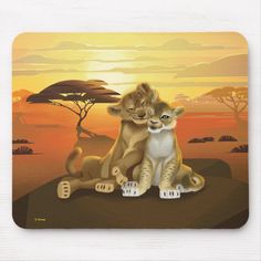 two lions sitting on top of each other in front of an african sunset mouse pad