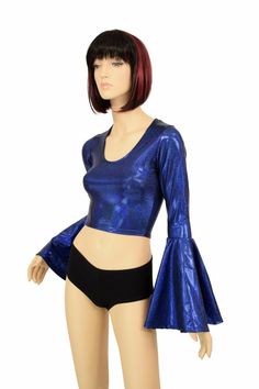 "This item is made to order, please read all the way through the listing before purchasing! This shiny, sparkling holographic top is made of spandex in a beautiful blue sparkly jewel holographic. It features a scoop neckline in front and Trumpet sleeves. Four way stretch spandex for a great fit! TOP LENGTH: Underarm to hemline measures 8\" Womens Sizing (See below for instructions on where measurements should be taken) XXS: Bust 29\"-30\" / Waist 22\"-23\" / Hips 30\"-32\" Extra Small: Bust 31\" Blue Stretch Crop Top For Club, Glamorous Shiny Stretch Tops, Fitted Iridescent Tops, Shiny Stretch Disco Tops, Stretchy Shiny Disco Tops, Metallic Shiny Disco Top, Fitted Metallic Shiny Tops, Metallic Shiny Fitted Tops, Metallic Shimmer Top For Disco