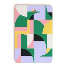 a wooden cutting board with an abstract design on the front and back cover in different colors