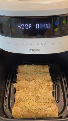 some food is being cooked in an air fryer with the timer on it's side