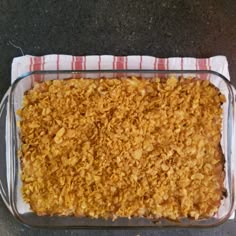 a glass casserole dish filled with food on top of a table