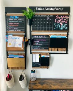 a wall mounted chalk board with calendars and office supplies