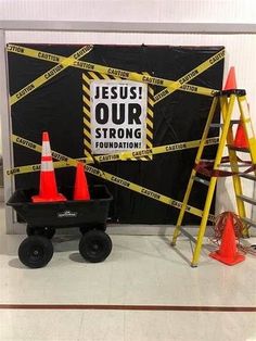 there is a sign that says jesus our strong foundation and some construction cones on the ground