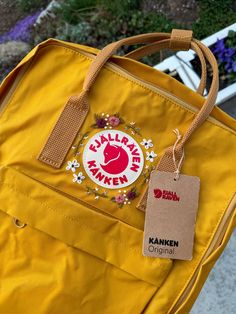 BRAND NEW - READY TO SHIP - Hand Embroidered Fjallraven Classic Kanken Floral Backpack. Color Ochre Yellow. FREE SHIPPING!  (the color from the camera looks off in some pics but the first photo is the closest)  technical details :  height : 36 cm width : 27.5 cm depth : 12 cm volume : 16 I weight : 300 g Fjallraven Kanken Yellow, Yellow Backpack Aesthetic, Embroidery On Kanken, Brown Travel Bag With Embroidered Logo, Embroidered Patch Backpack For Everyday Use, Floral Embroidery Travel Backpack, Everyday Backpack With Embroidered Logo, Standard Backpack With Embroidered Logo For Daily Use, Daily Use Backpack With Embroidered Logo