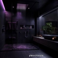 a modern bathroom with black walls and purple lighting on the shower head, sink and mirror