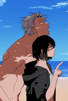 a man and woman standing next to each other on a beach