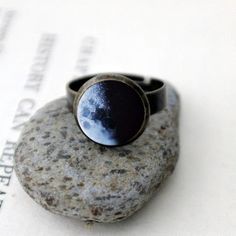 Ever wonder what the moon looked like on your birthday? Or the birth dates of your children? The day you got married? Or the date of a person you love who passed on? We can help you find out and create it into a beautiful, simple adjustable ring for you. Looks great with all of our other birth moon jewelry!To order, please provide the following information : Date (in this format: MM/DD/YYYY), Time Zone, and Approximate Time Of Day (if possible) of the date you wish to celebrate. We will verify y Adjustable Moon Charm Ring, Adjustable Moon Phase Rings For Anniversary, Celestial Moon Phase Rings As Gift, Adjustable Moon Phase Ring For Gift, Adjustable Vintage Rings With Sun And Moon Design, Vintage Adjustable Rings With Sun And Moon Design, Celestial Moon-shaped Ring As A Gift, Moon Shaped Rings With Moon Charm For Anniversary, Celestial Moon Shaped Rings For Gifts