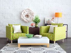 a living room with green and white furniture