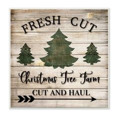 a wooden sign that says fresh cut christmas tree farm, cut and haul on it