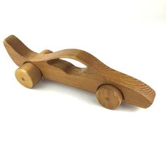 a wooden toy car on a white background