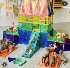 an assortment of plastic toys including animals, and a slide in the shape of a house