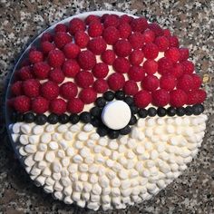 a cake decorated with raspberries and white frosting