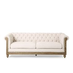 a white couch sitting on top of a wooden frame