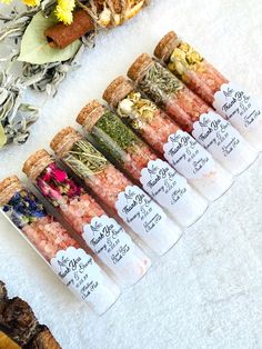 a bunch of different types of food on display in front of some dried flowers and herbs