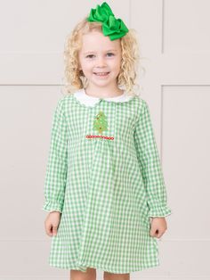 Gather the kiddos around the tree in this charming sibling set! This dress boasts a beautiful kelly green gingham print with peter pan collar and embroidered Christmas tree. Fits true to size. 100% Cotton Accessories sold separately. Suggest bow color #1 and #22. Import. Eloise is 41 lbs and 41 inches tall wearing size L (4 YRS). *Afterpay and Sezzle Purchase Requires $35 Minimum Order. Embroidered Christmas Tree, Cotton Accessories, Embroidered Christmas, Green Gingham, Gingham Dress, Gingham Print, Pan Collar, Peter Pan Collar, Kelly Green