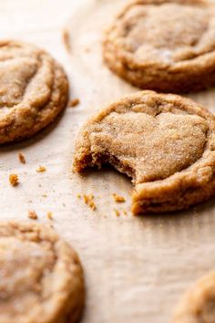 several cookies are on a baking sheet with one cookie missing