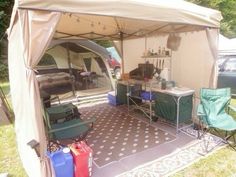 the inside of a tent with chairs, tables and other items in it on a lawn