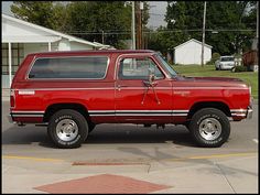 a red pick up truck parked in a parking lot