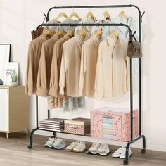 an iron rack with clothes and shoes on it