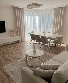 a living room filled with furniture and a flat screen tv