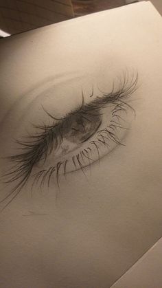 a drawing of an eye with long lashes on it's left side and the bottom part of its iris visible