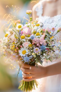 a woman holding a bouquet of flowers in her hands