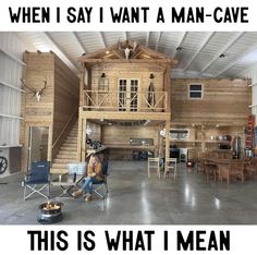 a man sitting in a chair next to a wooden house with the words when i say i want a man - cave, this is what i mean