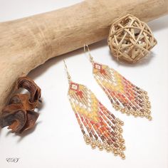 Large miyuki beaded fringe boho earrings gold orange copper yellow white Very long bohemian earrings with woven miyuki pearl fringes. Chic ethnic jewelry, inspirations from Native American jewelry. Golden orange copper yellow white colors. miyuki pearls and mini golden miyuki drops. Designed and made in France, French designer jewelry, handmade. Length: 10 Centimeters. Very light. Mounted on gilded metal hook supports, guaranteed nickel-free (can be modified on request). Delivered in its small o Handwoven Gold Jewelry For Summer, Gold Tassel Jewelry For Summer, Summer Gold Tassel Jewelry, Handwoven Gold Earrings For Summer, Yellow Handwoven Drop Earrings, Gold Bohemian Beaded Earrings, Bohemian Orange Tassel Earrings, Adjustable Gold Beaded Bohemian Earrings, Bohemian Gold Beaded Earrings With Colorful Beads