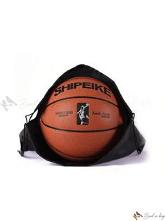 an orange and black basketball sitting on top of a gym bag with the word shipekie printed on it