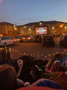 people are watching movies in the parking lot