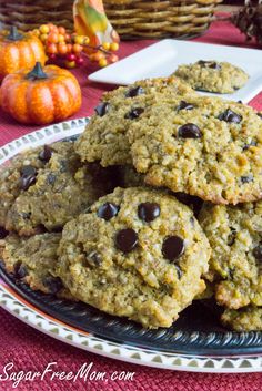 chocolate chip cookies on a plate with pumpkins in the background